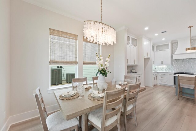 4046 Miramar Ct, Galveston, TX 77554 - dining area featuring a chandelier, light wood-style flooring, recessed lighting, ornamental molding, and baseboards