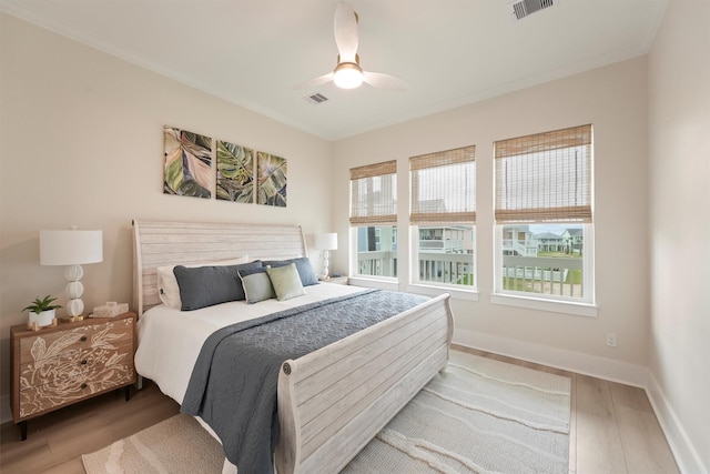 4046 Miramar Ct, Galveston, TX 77554 - bedroom with wood finished floors, crown molding, a ceiling fan, and baseboards