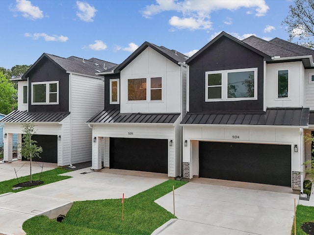 5014 Golden Forest Dr, Houston, TX 77091 - modern farmhouse featuring a standing seam roof, an attached garage, a shingled roof, concrete driveway, and metal roof