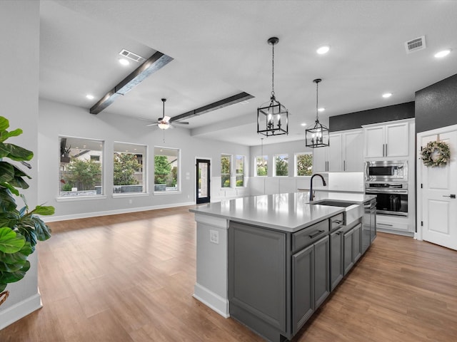 17511 Autumn Leaves Dr, Conroe, TX 77302 - kitchen featuring appliances with stainless steel finishes, gray cabinetry, a sink, a ceiling fan, and recessed lighting
