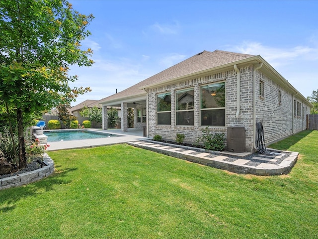 17511 Autumn Leaves Dr, Conroe, TX 77302 - back of house featuring brick siding, a patio, roof with shingles, and a ceiling fan