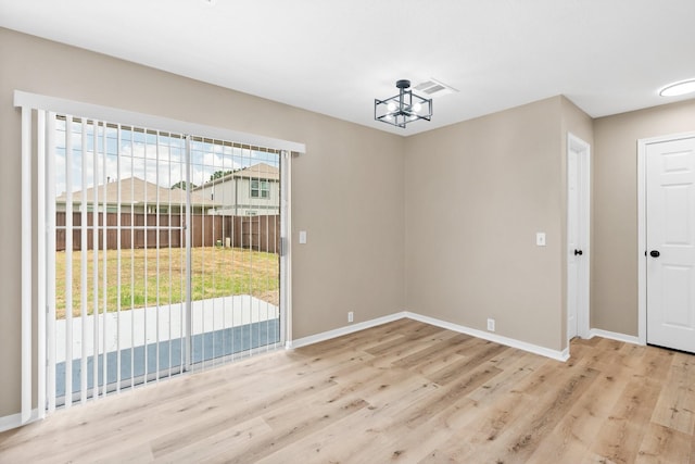19222 Wading River Dr, Tomball, TX 77375 - unfurnished room featuring wood finished floors, baseboards, and a chandelier