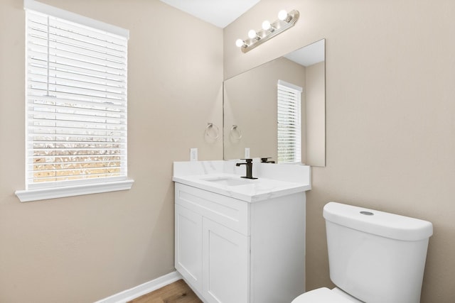 19222 Wading River Dr, Tomball, TX 77375 - half bathroom with vanity, toilet, and baseboards