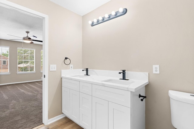 19222 Wading River Dr, Tomball, TX 77375 - bathroom with toilet, a ceiling fan, double vanity, and baseboards