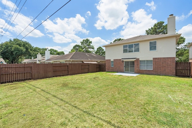 19222 Wading River Dr, Tomball, TX 77375 - back of property featuring brick siding, a patio, and a chimney