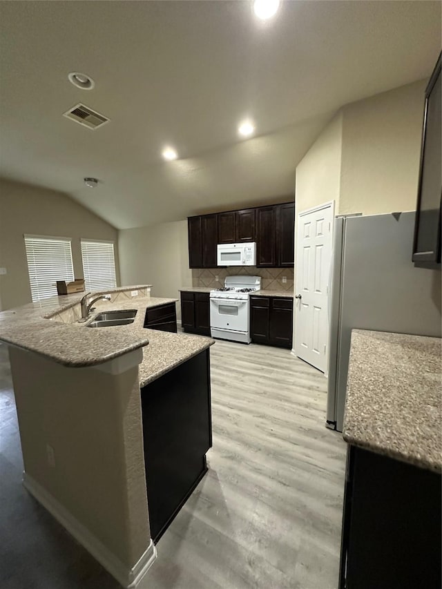 3423 Single Ridge Way, Katy, TX 77493 - kitchen with white appliances, a sink, lofted ceiling, recessed lighting, and decorative backsplash