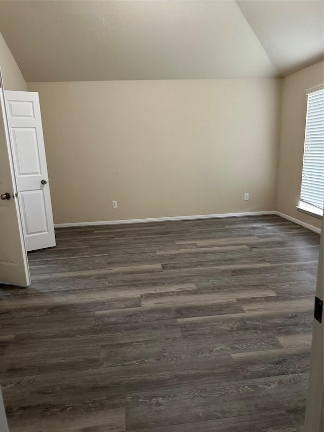 3423 Single Ridge Way, Katy, TX 77493 - empty room with lofted ceiling, dark wood-type flooring, and baseboards
