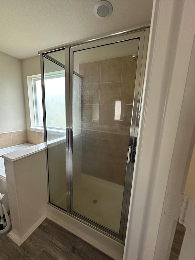 3423 Single Ridge Way, Katy, TX 77493 - bathroom with wood finished floors, a shower stall, and a textured ceiling