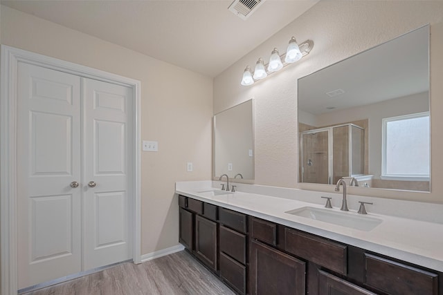 3423 Single Ridge Way, Katy, TX 77493 - bathroom featuring double vanity, a stall shower, and wood finished floors