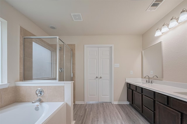 3423 Single Ridge Way, Katy, TX 77493 - full bath with a bath, double vanity, a stall shower, and wood finished floors