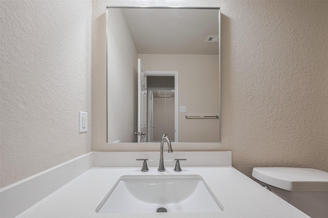 3423 Single Ridge Way, Katy, TX 77493 - bathroom featuring a textured wall, toilet, and vanity