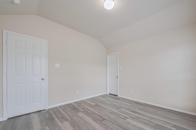 3423 Single Ridge Way, Katy, TX 77493 - spare room featuring lofted ceiling, wood finished floors, and baseboards