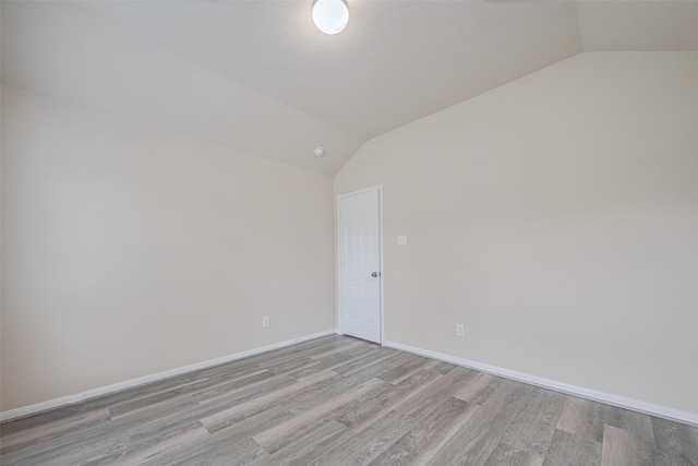 3423 Single Ridge Way, Katy, TX 77493 - spare room featuring vaulted ceiling, wood finished floors, and baseboards