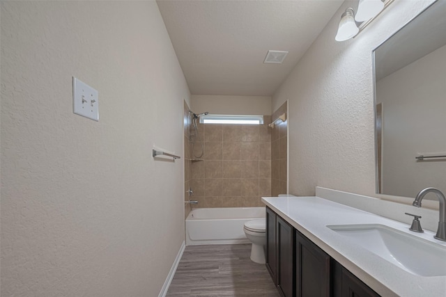 3423 Single Ridge Way, Katy, TX 77493 - full bathroom featuring vanity, wood finished floors, a textured wall, shower / tub combination, and toilet