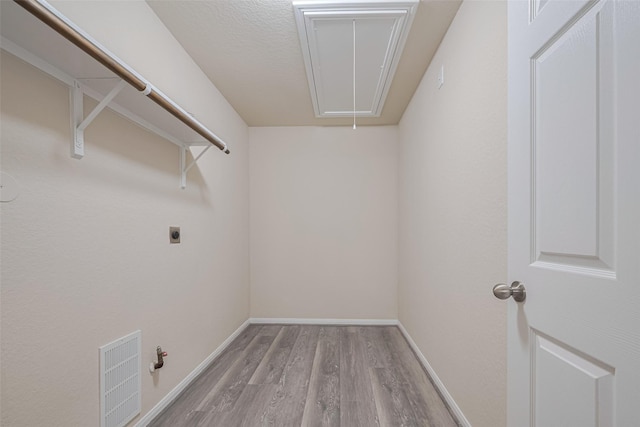 3423 Single Ridge Way, Katy, TX 77493 - laundry area with attic access, electric dryer hookup, wood finished floors, baseboards, and hookup for a gas dryer