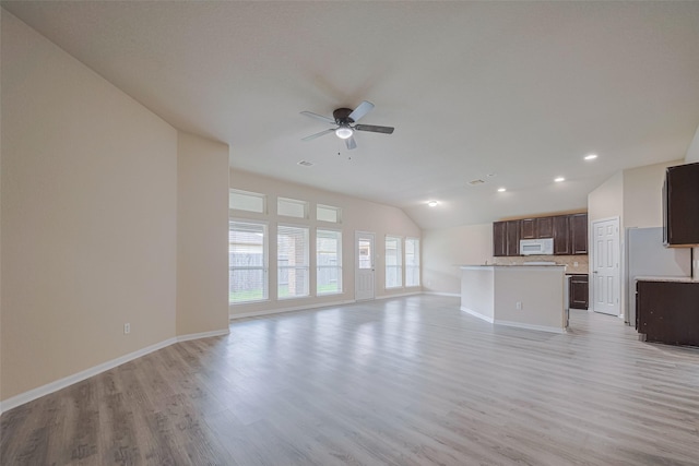 3423 Single Ridge Way, Katy, TX 77493 - unfurnished living room with a ceiling fan, lofted ceiling, baseboards, light wood finished floors, and recessed lighting