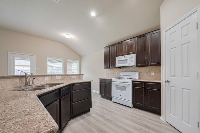 3423 Single Ridge Way, Katy, TX 77493 - kitchen with white appliances, a sink, vaulted ceiling, decorative backsplash, and dark brown cabinets