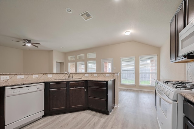 3423 Single Ridge Way, Katy, TX 77493 - kitchen with white appliances, a sink, tasteful backsplash, plenty of natural light, and vaulted ceiling