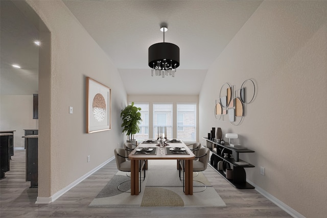 3423 Single Ridge Way, Katy, TX 77493 - dining room featuring wood finished floors, vaulted ceiling, baseboards, a chandelier, and a textured wall