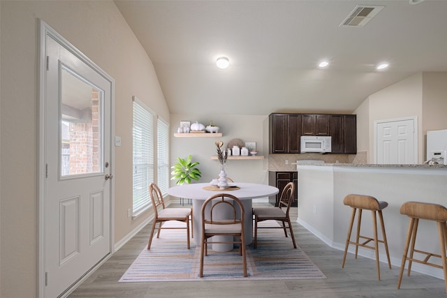 3423 Single Ridge Way, Katy, TX 77493 - dining space with lofted ceiling, light wood-type flooring, recessed lighting, and baseboards