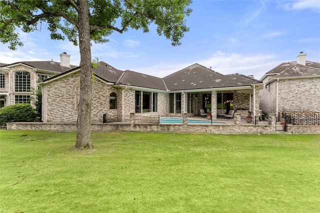 2722 N Southern Oaks Dr, Houston, TX 77068 - back of house featuring a yard, brick siding, a tile roof, a patio area, and an outdoor pool