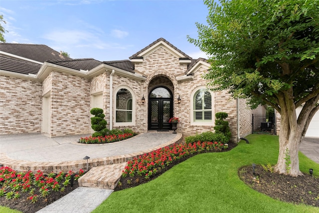 2722 N Southern Oaks Dr, Houston, TX 77068 - view of front facade with french doors, brick siding, and a tiled roof