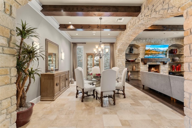 2722 N Southern Oaks Dr, Houston, TX 77068 - dining area with beamed ceiling, stone tile floors, a fireplace, a chandelier, and crown molding