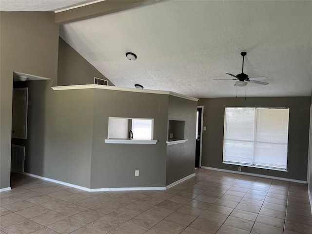 2503 Ironclad Dr, League City, TX 77573 - unfurnished room featuring a textured ceiling, a ceiling fan, light tile patterned floors, lofted ceiling, and baseboards