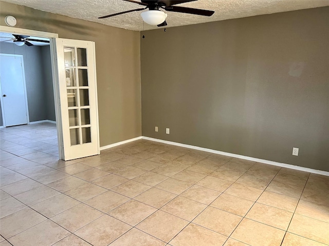 2503 Ironclad Dr, League City, TX 77573 - empty room featuring a ceiling fan, a textured ceiling, light tile patterned flooring, baseboards, and a smoke detector