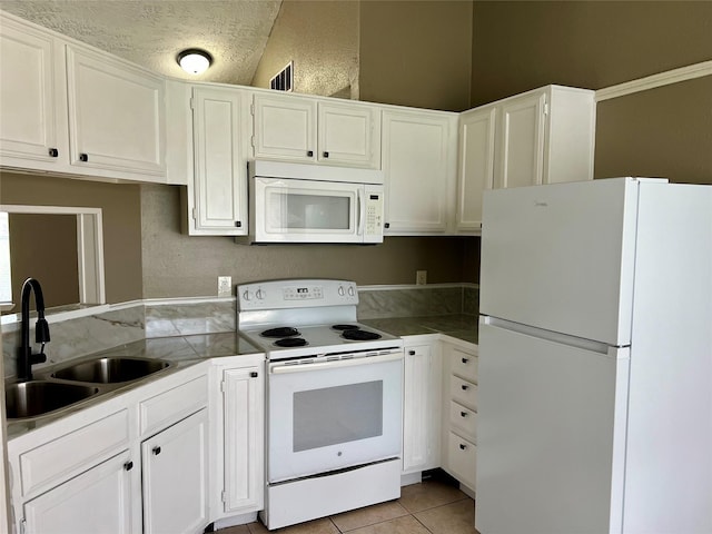 2503 Ironclad Dr, League City, TX 77573 - kitchen featuring white appliances, a sink, white cabinets, and light tile patterned floors
