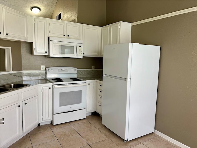 2503 Ironclad Dr, League City, TX 77573 - kitchen featuring white appliances, a sink, light tile patterned floors, and white cabinetry