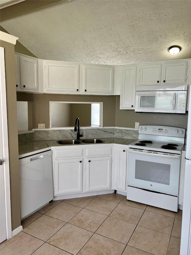 2503 Ironclad Dr, League City, TX 77573 - kitchen featuring white appliances, a sink, light tile patterned floors, white cabinets, and a textured ceiling