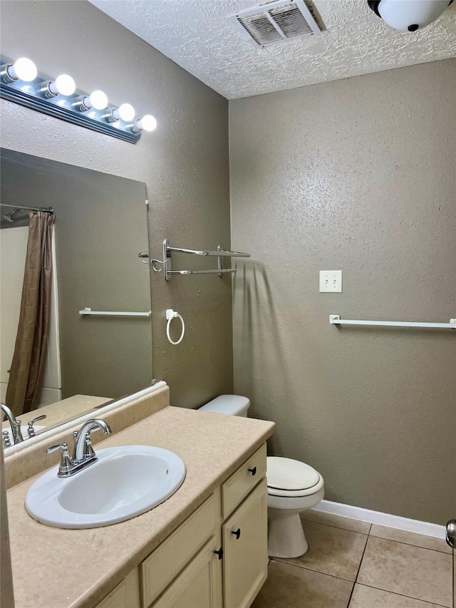 2503 Ironclad Dr, League City, TX 77573 - bathroom featuring toilet, a textured ceiling, vanity, tile patterned floors, and a textured wall