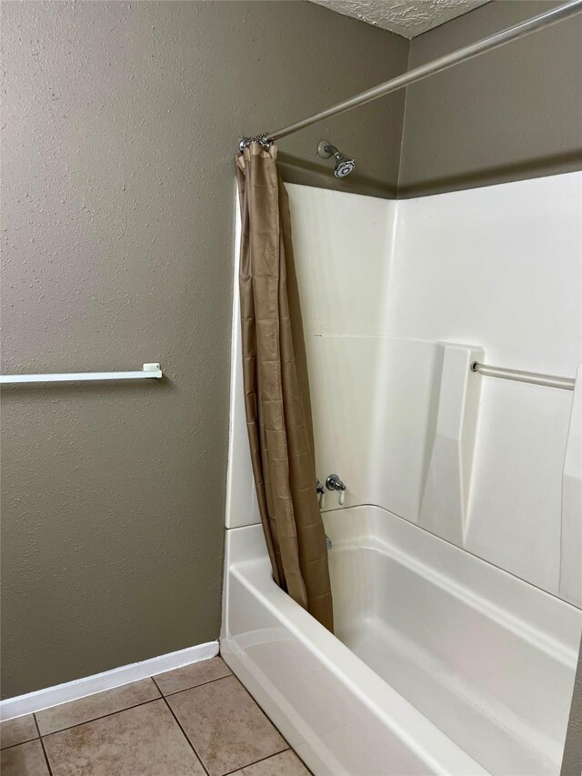 2503 Ironclad Dr, League City, TX 77573 - bathroom with shower / tub combo with curtain, baseboards, and tile patterned flooring