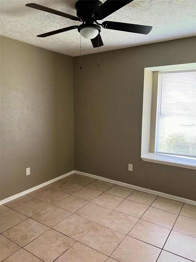 2503 Ironclad Dr, League City, TX 77573 - unfurnished room featuring a textured ceiling, light tile patterned floors, ceiling fan, and baseboards