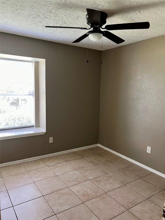 2503 Ironclad Dr, League City, TX 77573 - spare room featuring light tile patterned floors, ceiling fan, baseboards, and a textured ceiling