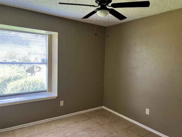 2503 Ironclad Dr, League City, TX 77573 - spare room featuring ceiling fan, a textured ceiling, light tile patterned floors, and baseboards