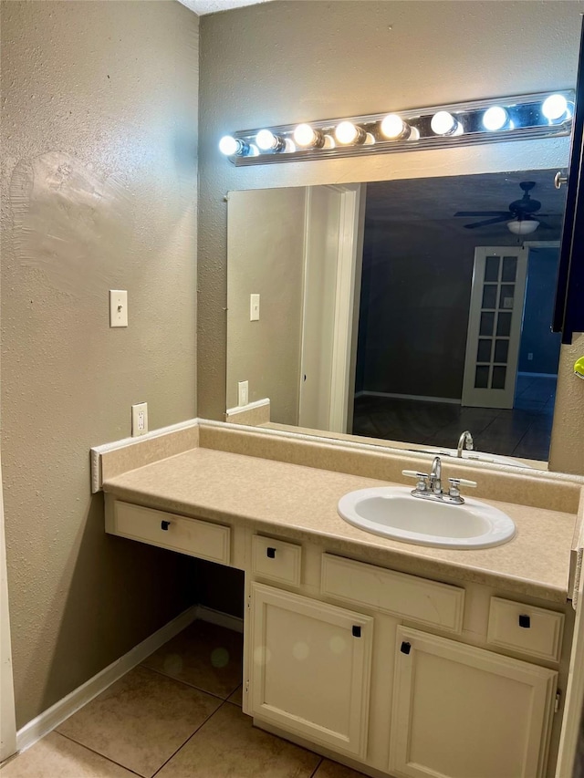 2503 Ironclad Dr, League City, TX 77573 - bathroom featuring tile patterned flooring, vanity, a textured wall, baseboards, and ceiling fan