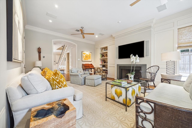 3428 Wickersham Ln, Houston, TX 77027 - living room with a ceiling fan, arched walkways, built in shelves, a fireplace, and recessed lighting