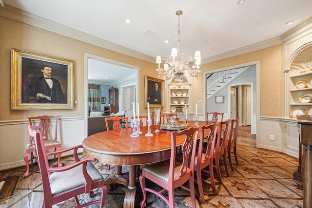 3428 Wickersham Ln, Houston, TX 77027 - dining room featuring built in shelves, crown molding, a chandelier, wainscoting, and recessed lighting