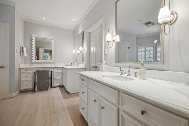 3428 Wickersham Ln, Houston, TX 77027 - bathroom with ornamental molding, wood finished floors, two vanities, and wallpapered walls
