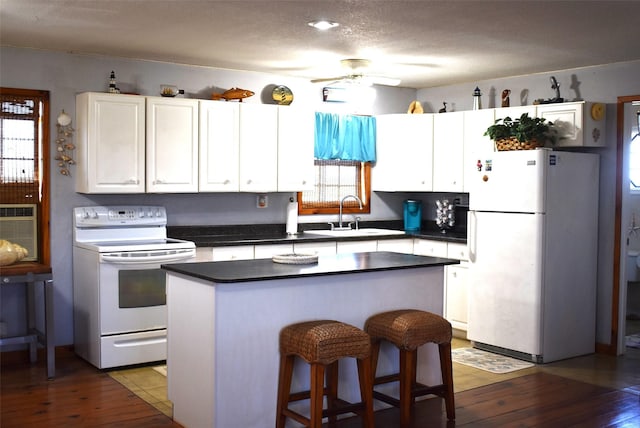 26656 Fm 457, Sargent, TX 77414 - kitchen with white appliances, a sink, wood-type flooring, and a ceiling fan
