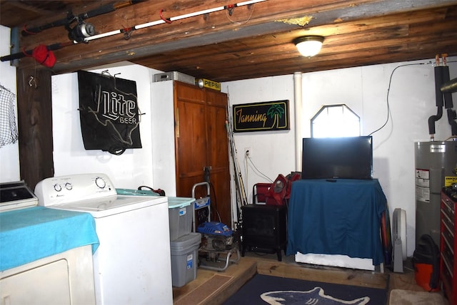 26656 Fm 457, Sargent, TX 77414 - laundry area with water heater, washer and clothes dryer, and a wood stove