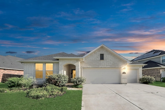 8034 Royal Palm Dr, Fulshear, TX 77441 - view of front of house with an attached garage, brick siding, concrete driveway, and a shingled roof
