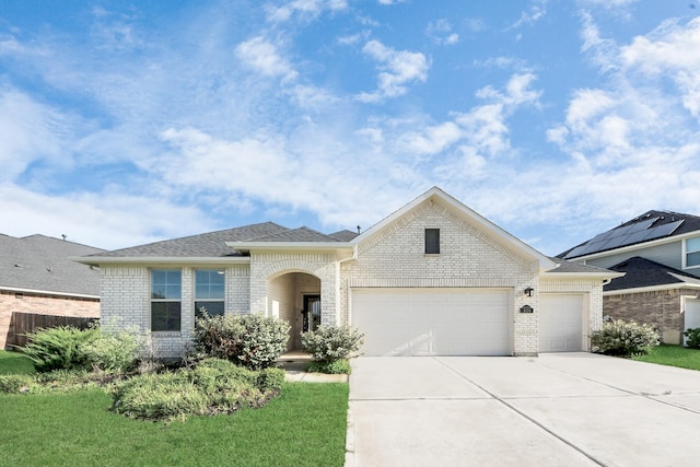 8034 Royal Palm Dr, Fulshear, TX 77441 - view of front of property featuring a garage, brick siding, driveway, and roof with shingles
