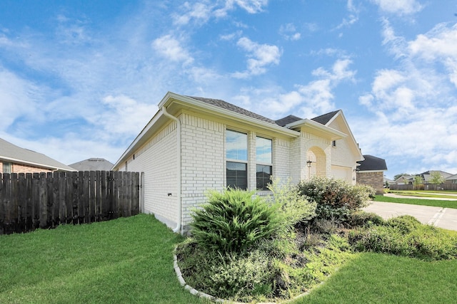 8034 Royal Palm Dr, Fulshear, TX 77441 - view of side of home with brick siding, concrete driveway, and an attached garage