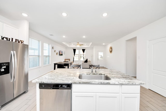 8034 Royal Palm Dr, Fulshear, TX 77441 - kitchen featuring stainless steel appliances, a sink, white cabinetry, an island with sink, and recessed lighting