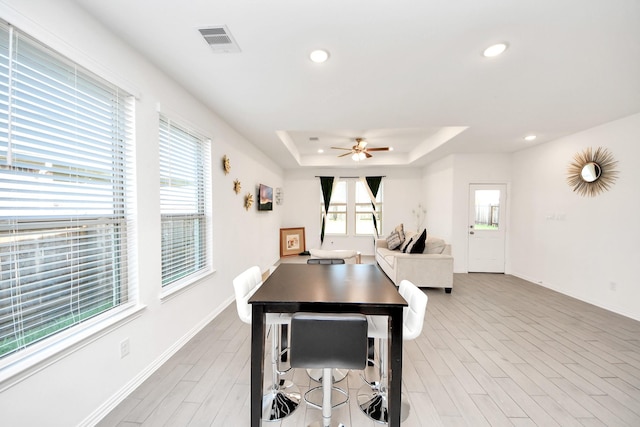 8034 Royal Palm Dr, Fulshear, TX 77441 - dining space featuring recessed lighting, a raised ceiling, baseboards, ceiling fan, and light wood-type flooring