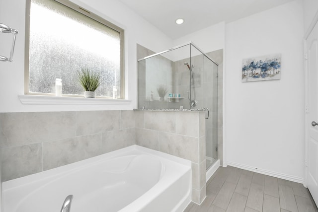 8034 Royal Palm Dr, Fulshear, TX 77441 - full bathroom featuring a garden tub, a stall shower, baseboards, wood finished floors, and recessed lighting