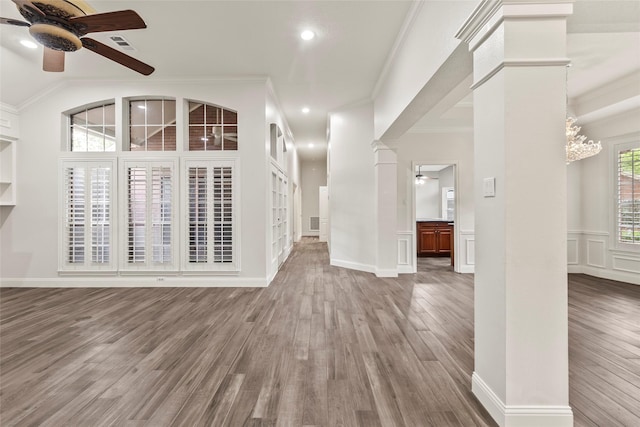 4206 Misty Timbers Way, Houston, TX 77345 - unfurnished living room featuring ceiling fan, wood finished floors, ornamental molding, a chandelier, and decorative columns